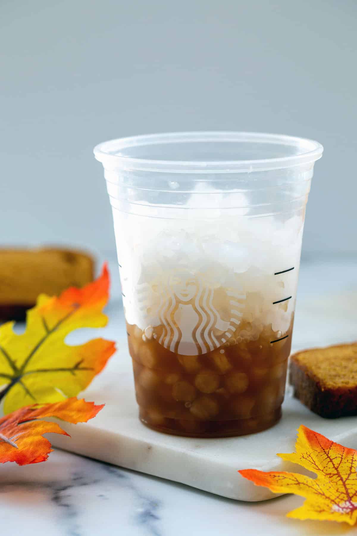 Chai latte concentrate in cup with ice.