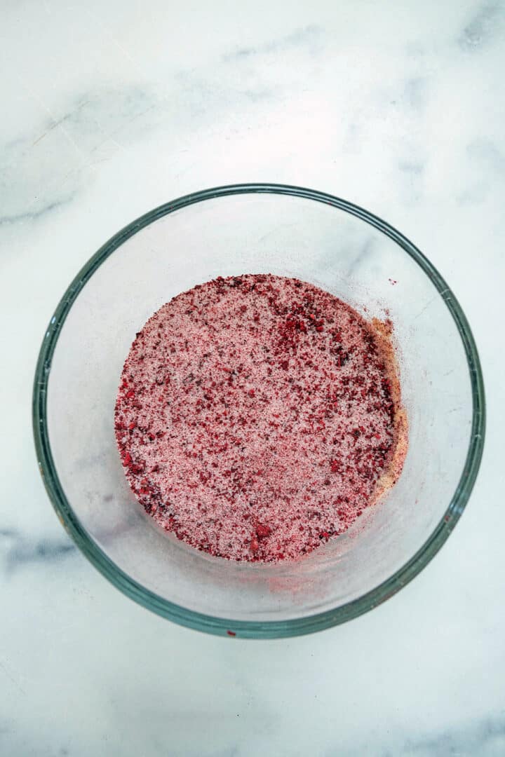 Ground freeze-dried cherries mixed with granulated sugar in small bowl.