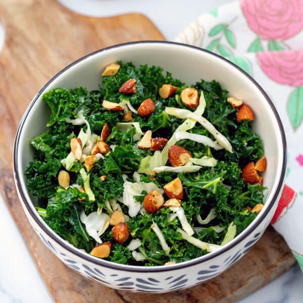 Closeup view of a Chick-Fil-A kale salad with green cabbage and almonds.