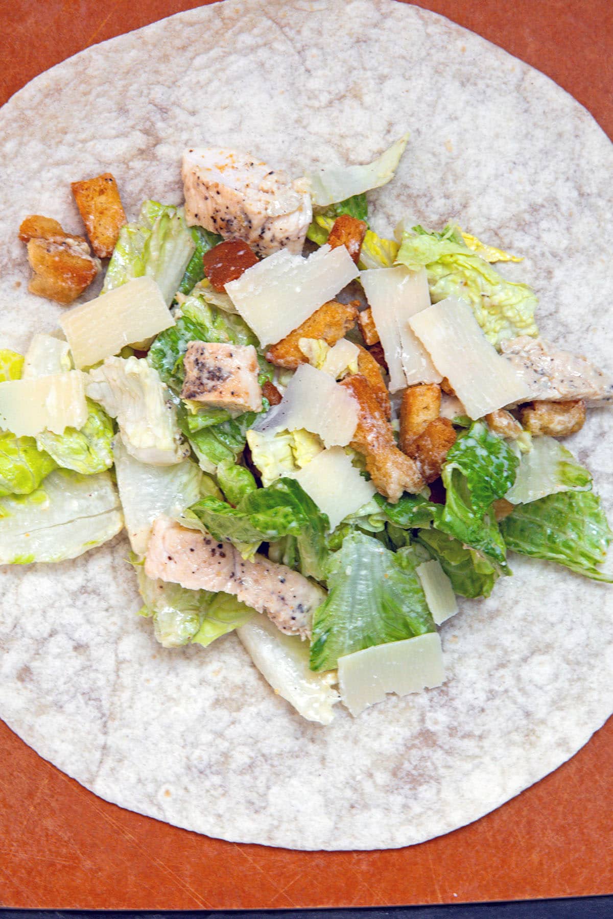 Chicken caesar salad on a wrap.