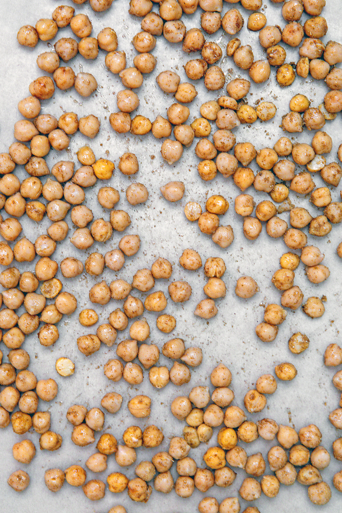 Seasoned chickpeas on baking sheet.