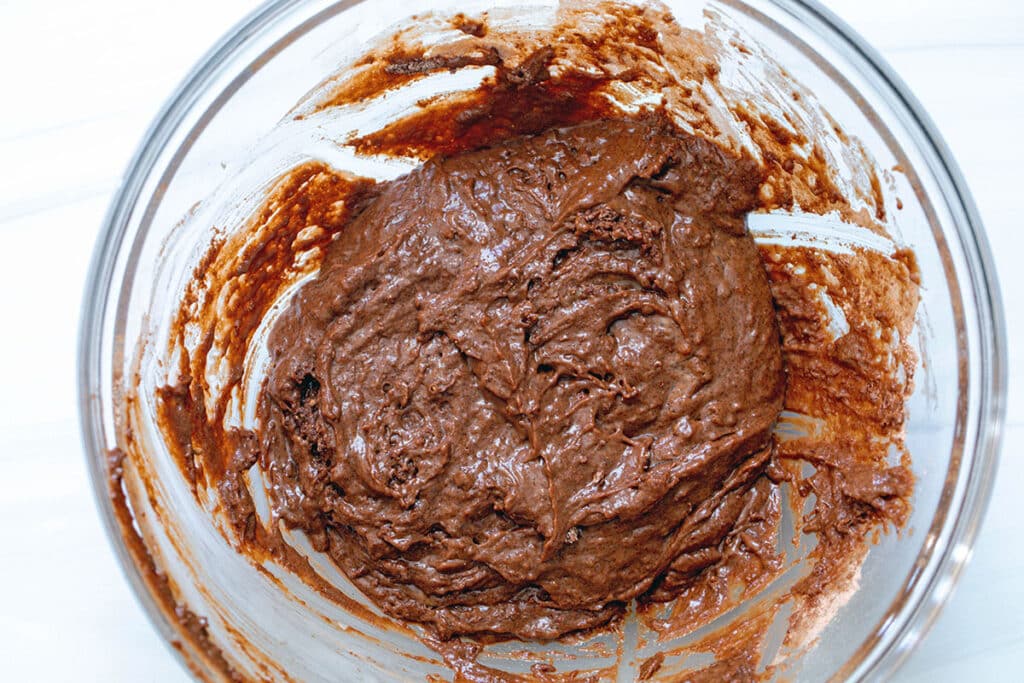 Chocolate donut batter in a mixing bowl.