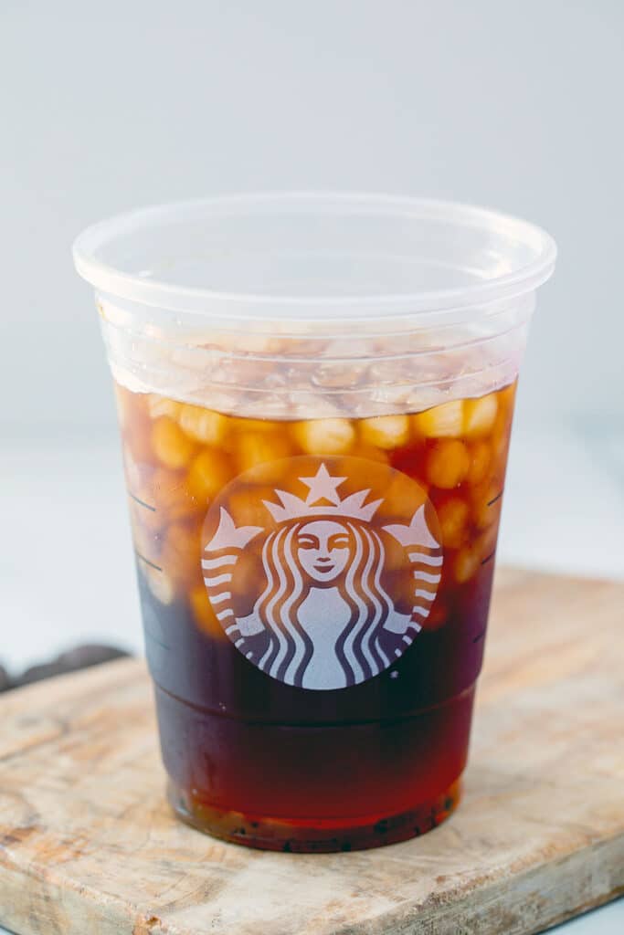 Starbucks cup filled with ice and cold brew.