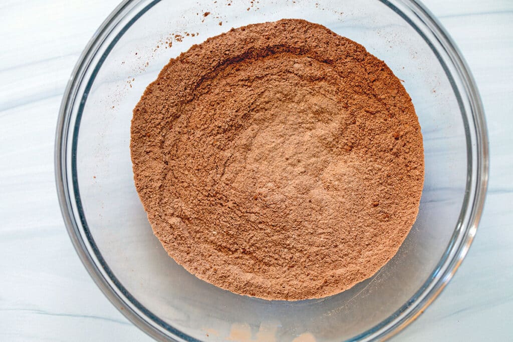 Flour, cocoa powder, sugar, and baking powder in a mixing bowl.