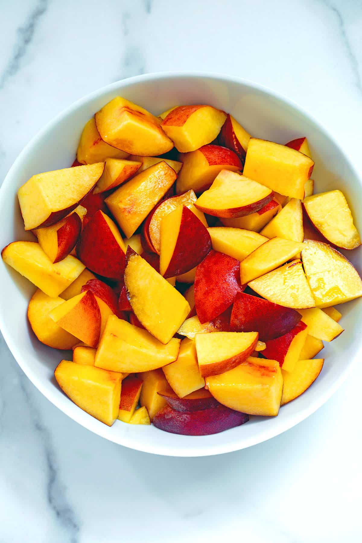 Sliced peaches in a bowl.