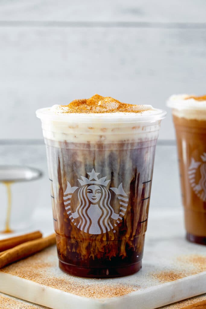 Starbucks cup with cinnamon caramel cream cold brew topped with cinnamon sugar.