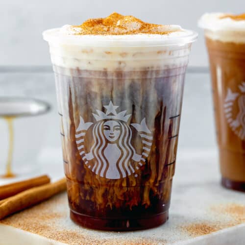 Close-up view of a cinnamon caramel cold brew coffee in Starbucks cup.