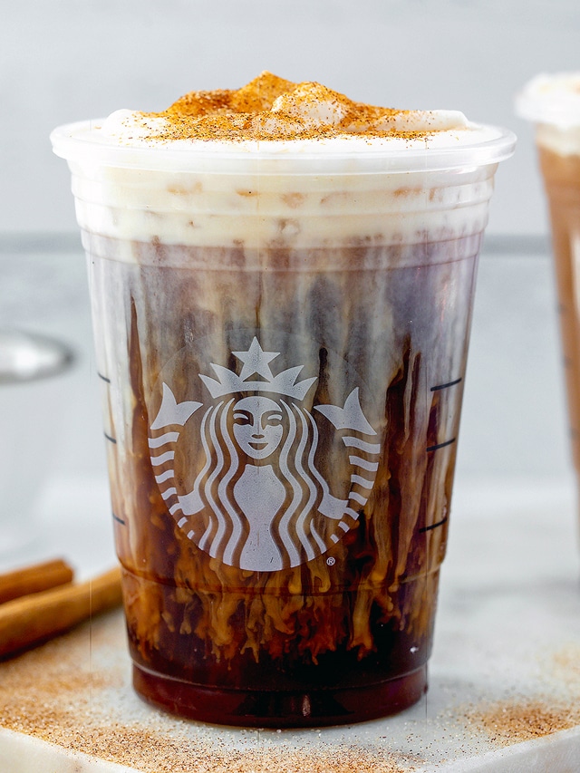 Head-on view of a cinnamon caramel cream cold brew in Starbucks cup.