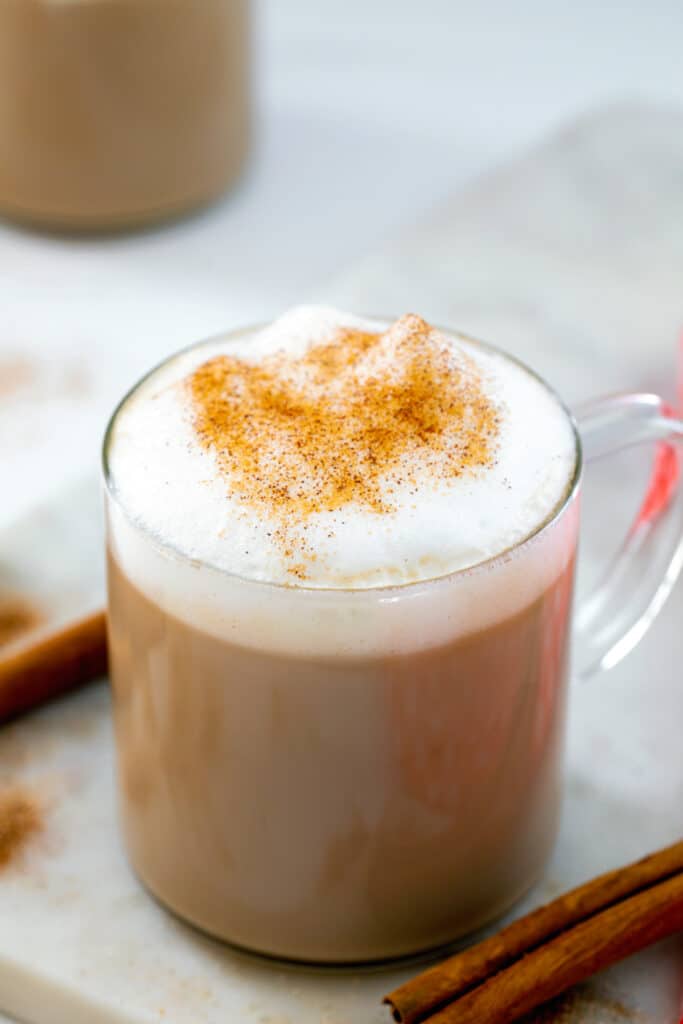 Overhead view of a cinnamon dolce latte topped with foam and ground cinnamon.