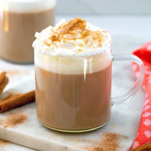Closeup view of a cinnamon dolce latte with whipped cream and ground cinnamon.