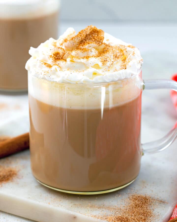 Closeup view of a cinnamon dolce latte with whipped cream and ground cinnamon.