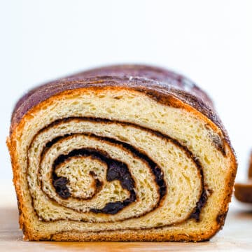Closeup view of cinnamon raisin bread loaf with cinnamon swirl visable.