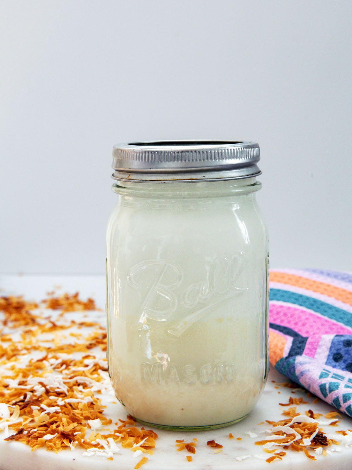 Head-on view of a mason jar with toasted coconut sweet cream.