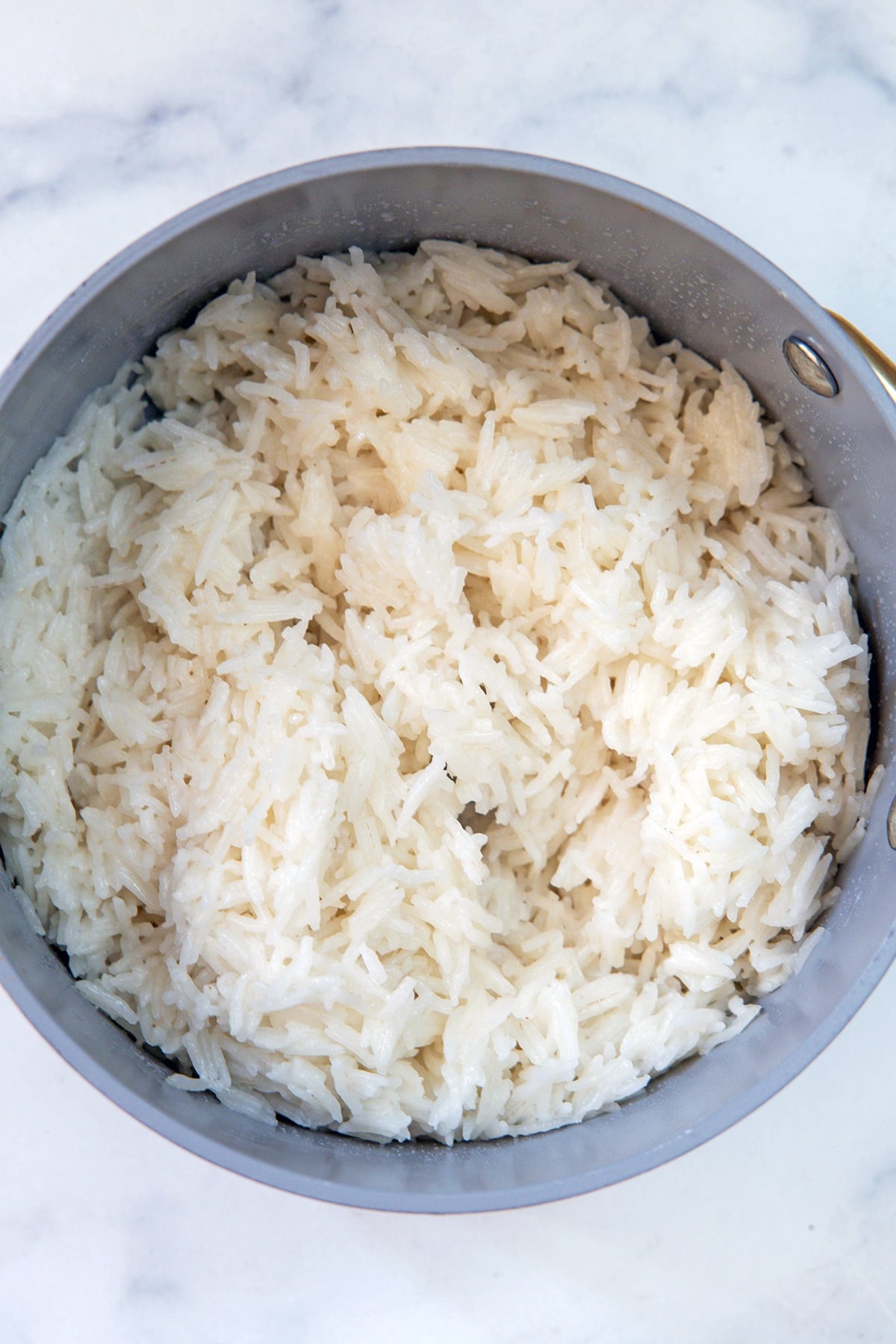 Coconut rice cooked in saucepan.