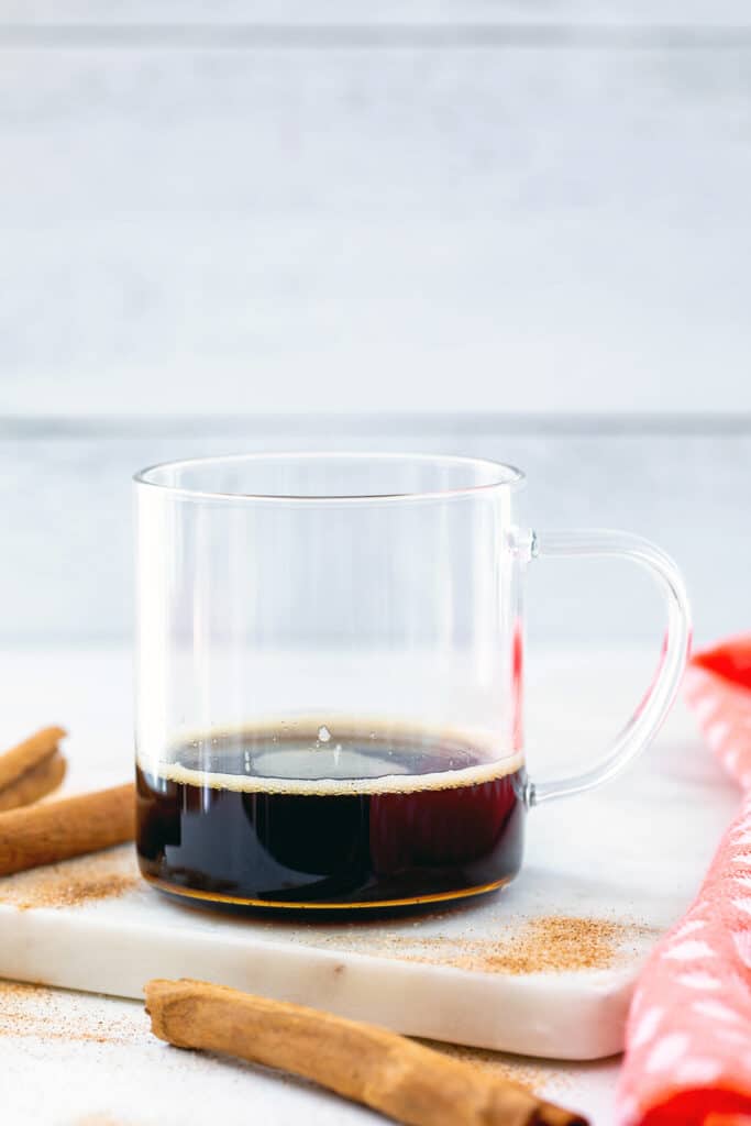 Espresso and cinnamon dolce syrup in a clear mug.