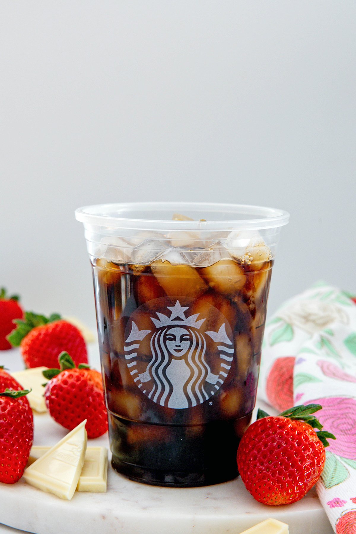Head-on view of a Starbucks cup filled with cold brew and ice.