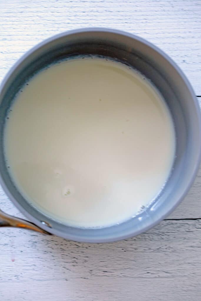 2% milk and condensed milk in saucepan.