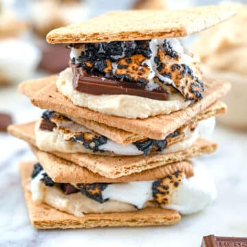 Closeup view of s'mores with toasted marshmallow, chocolate bar, and cookie dough.