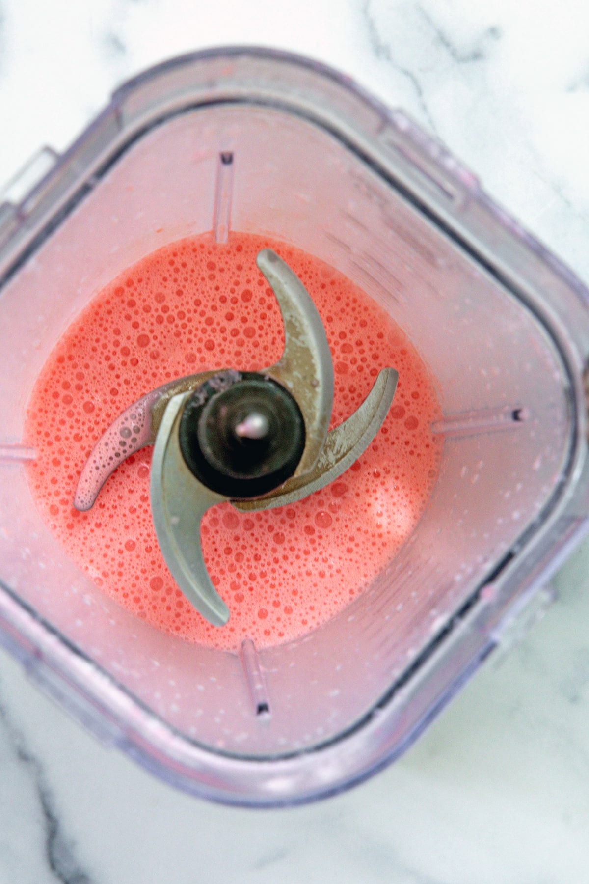 Overhead view of a otton candy Frappuccino in a blender.