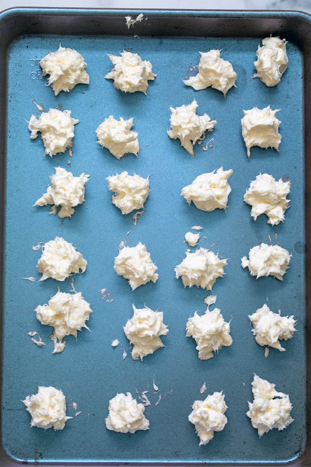 Cream cheese balls on baking sheet.