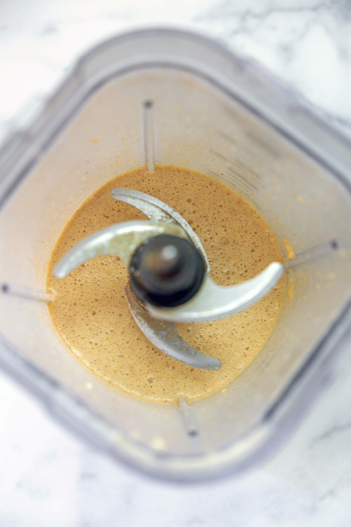 Overhead view of crepe batter in blender.
