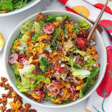 Closeup view of a crispy BLT pasta salad with fork.