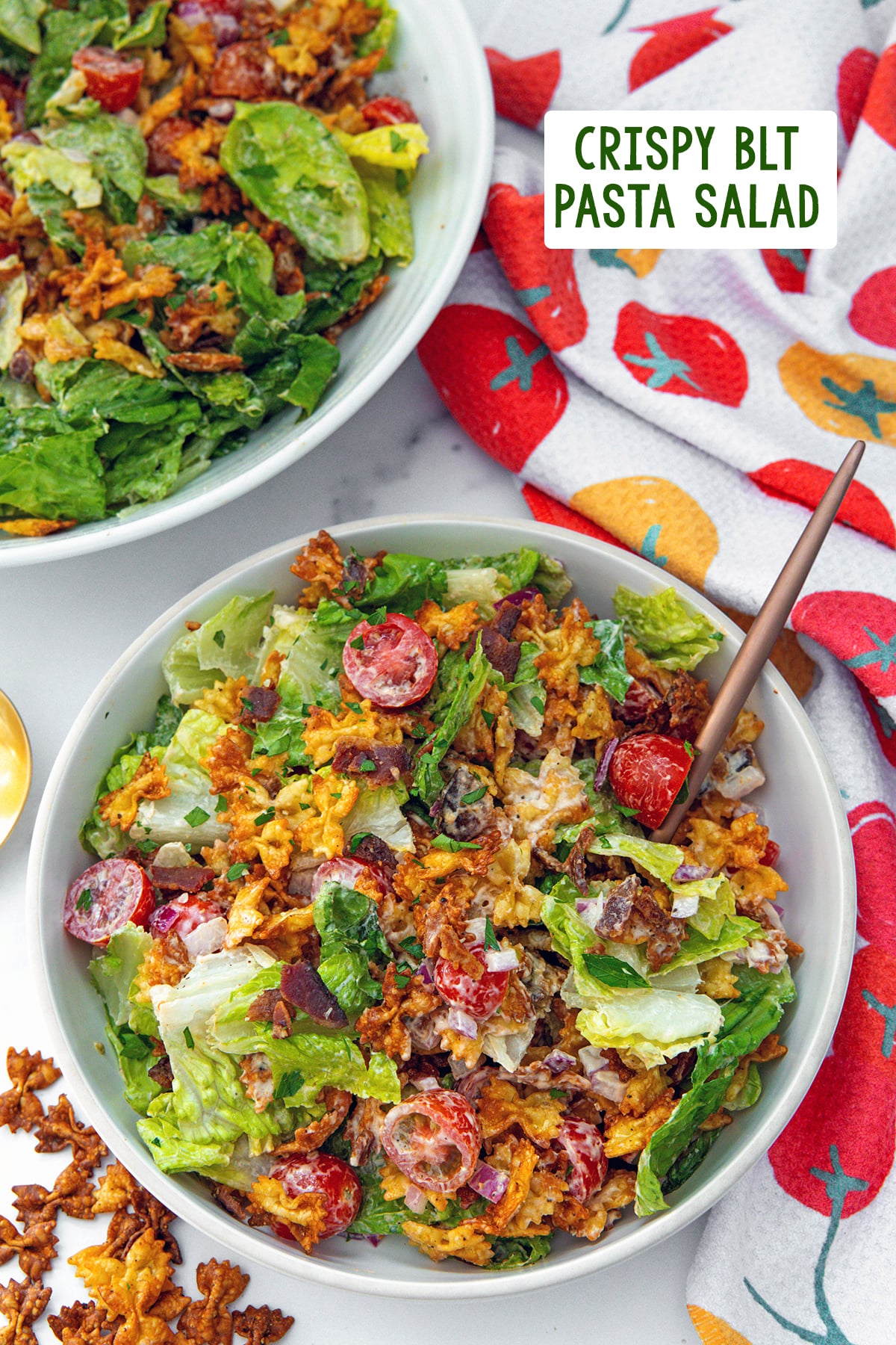 Overhead view of a a BLT salad with crispy pasta with second salad in the background, pasta on the side, and recipe title at top.