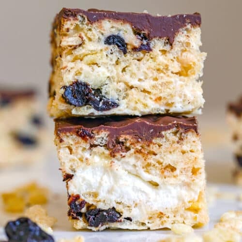 Closeup view of a stack of two rice krispies cherry treats with chocolate ganache.