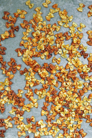 Crispy bowtie pasta on a bakign sheet.