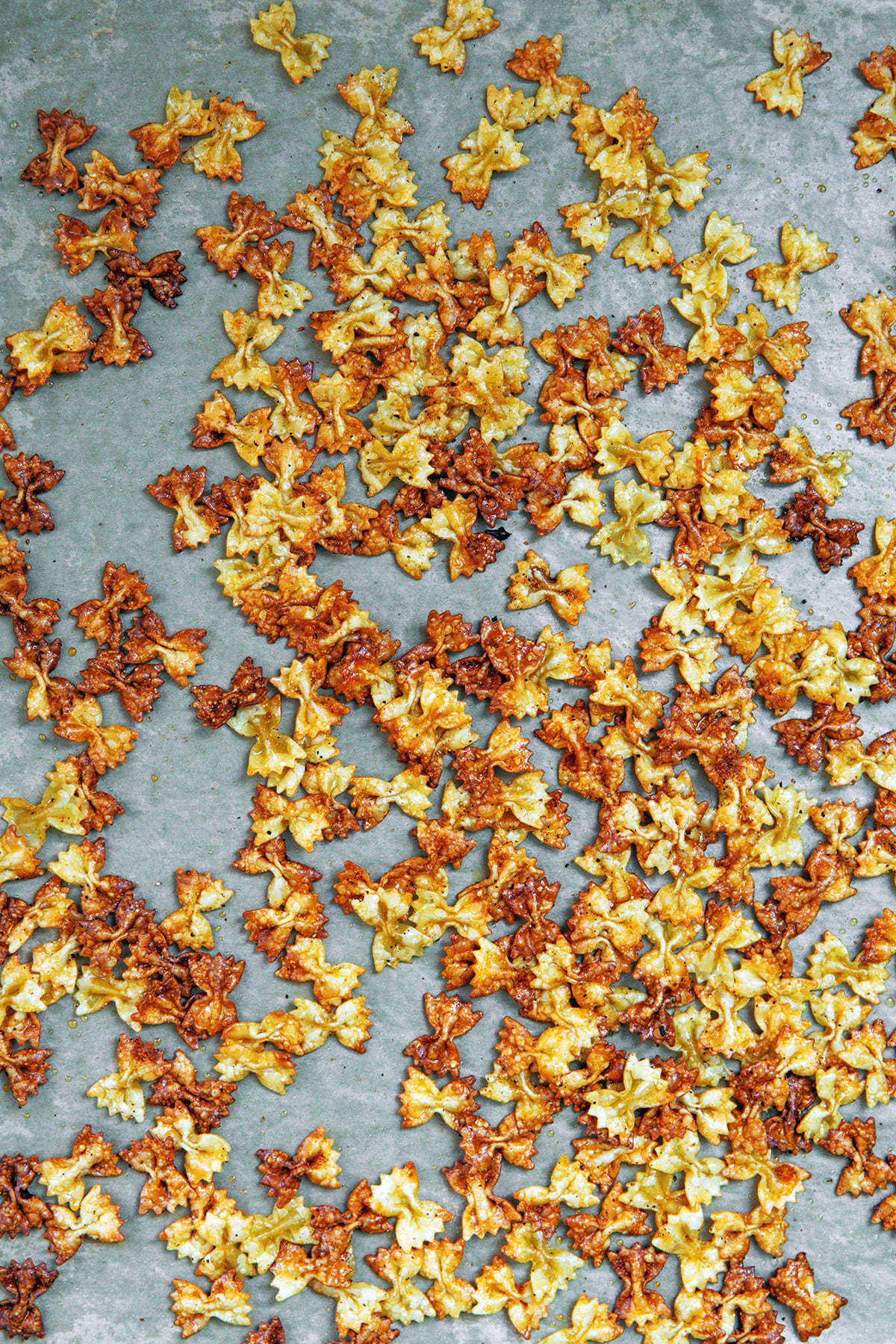 Crispy bowtie pasta on a bakign sheet.