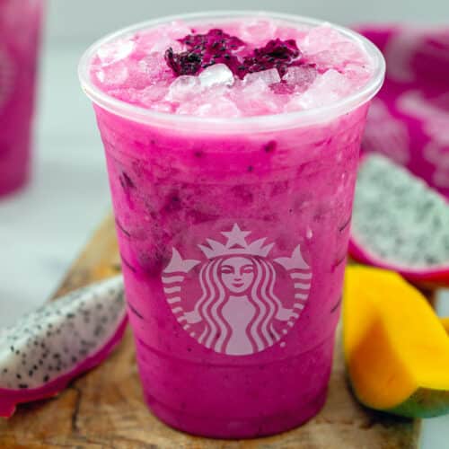 Close-up view of a Dragon Drink with mango and dragon fruit slices around.