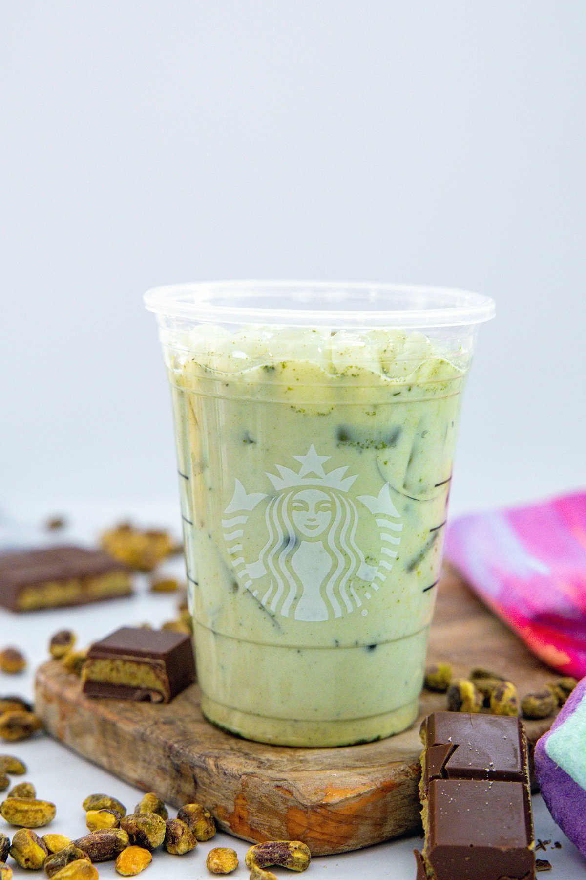 Head-on view of matcha mixed with milk in Starbucks cup.