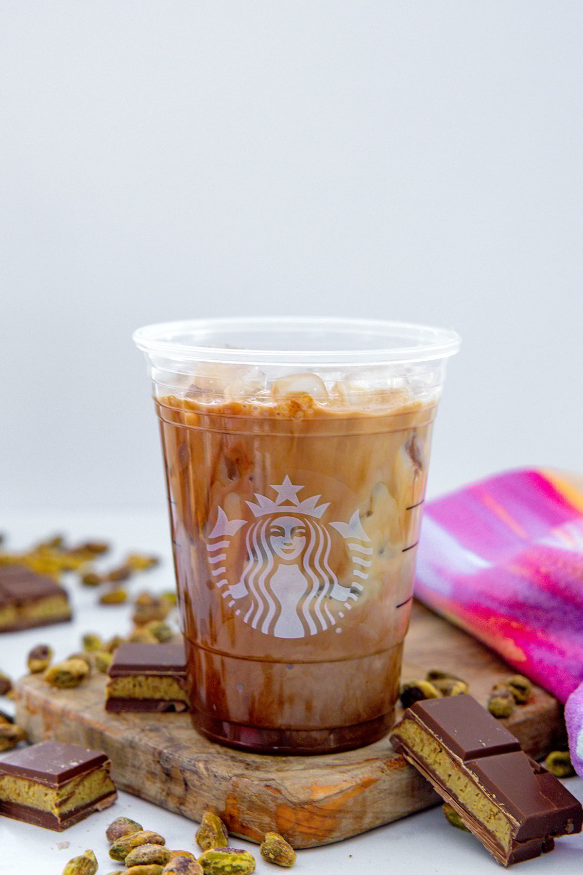 Head-on view of a Starbucks cup with coffee, mocha sauce, and milk.