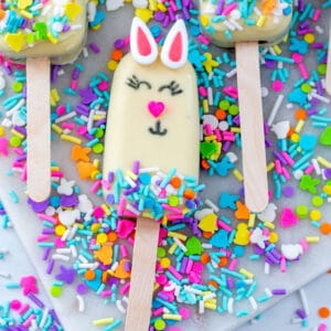 Overhead closeup view of an Easter cakesicle with sprinkles all around.