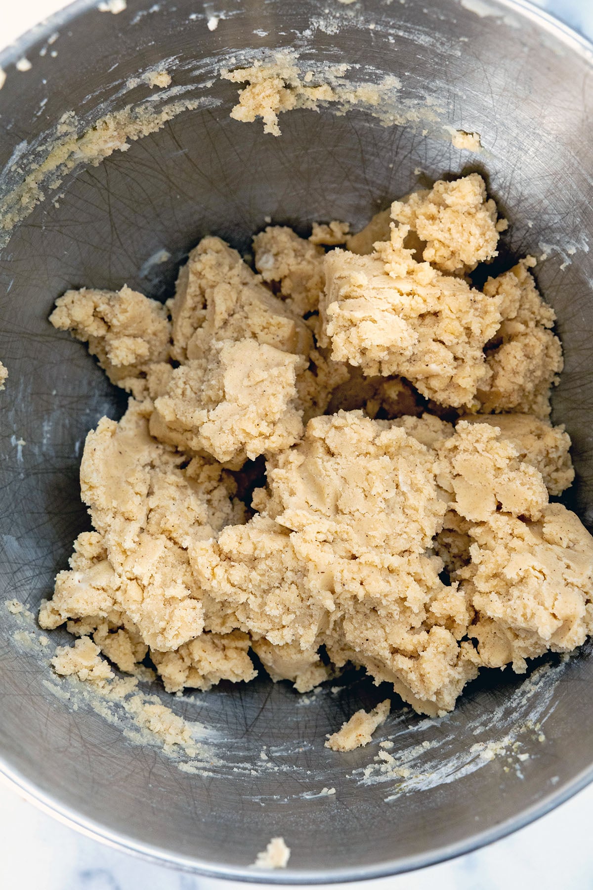 Eggnog thumbprint cookie dough in mixing bowl.