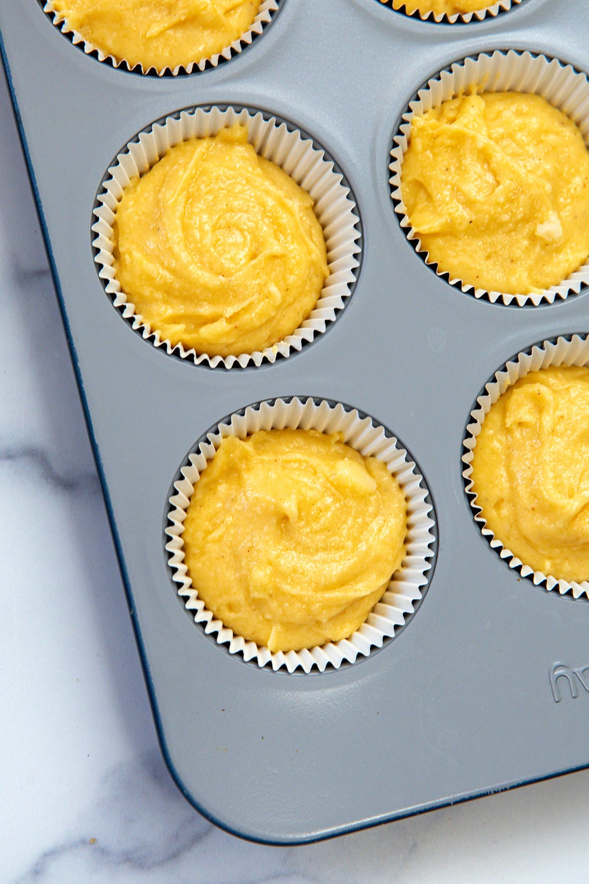 Eggnog cupcake batter in tin.