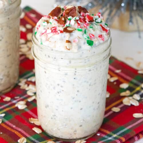 Closeup view of eggnog overnight oats with chopped pecans and sprinkles on top.