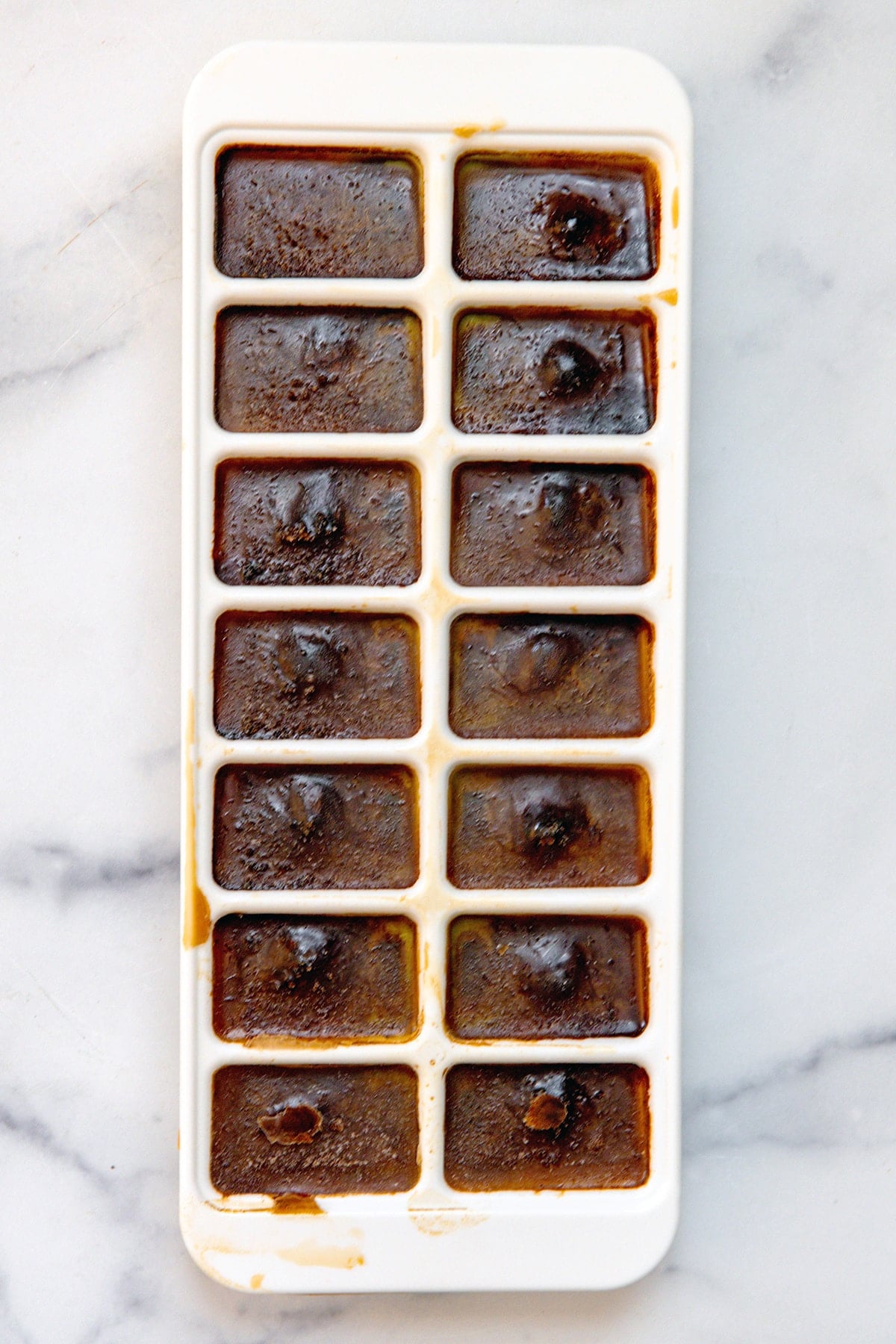 Espresso ice cubes in ice cube tray.
