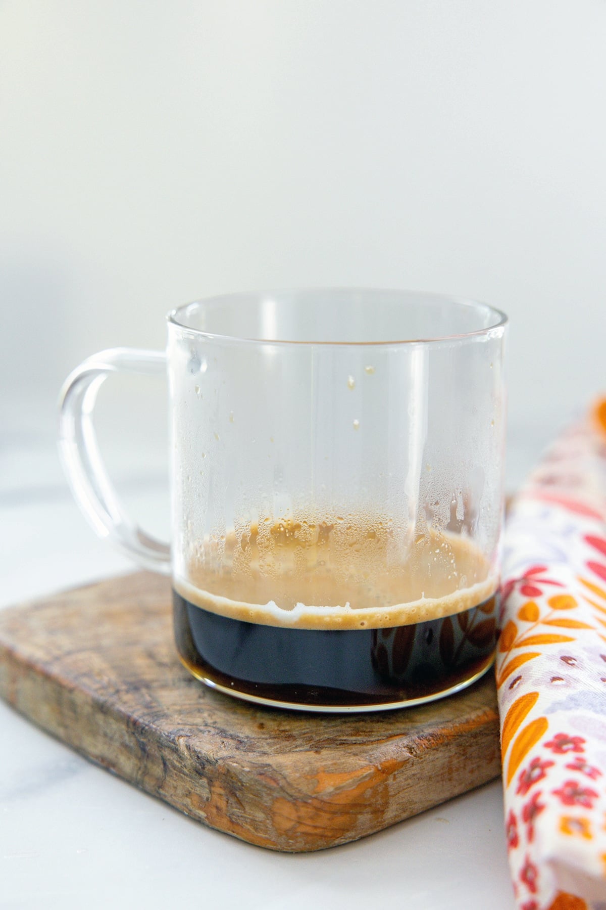 Espresso in clear glass mug.