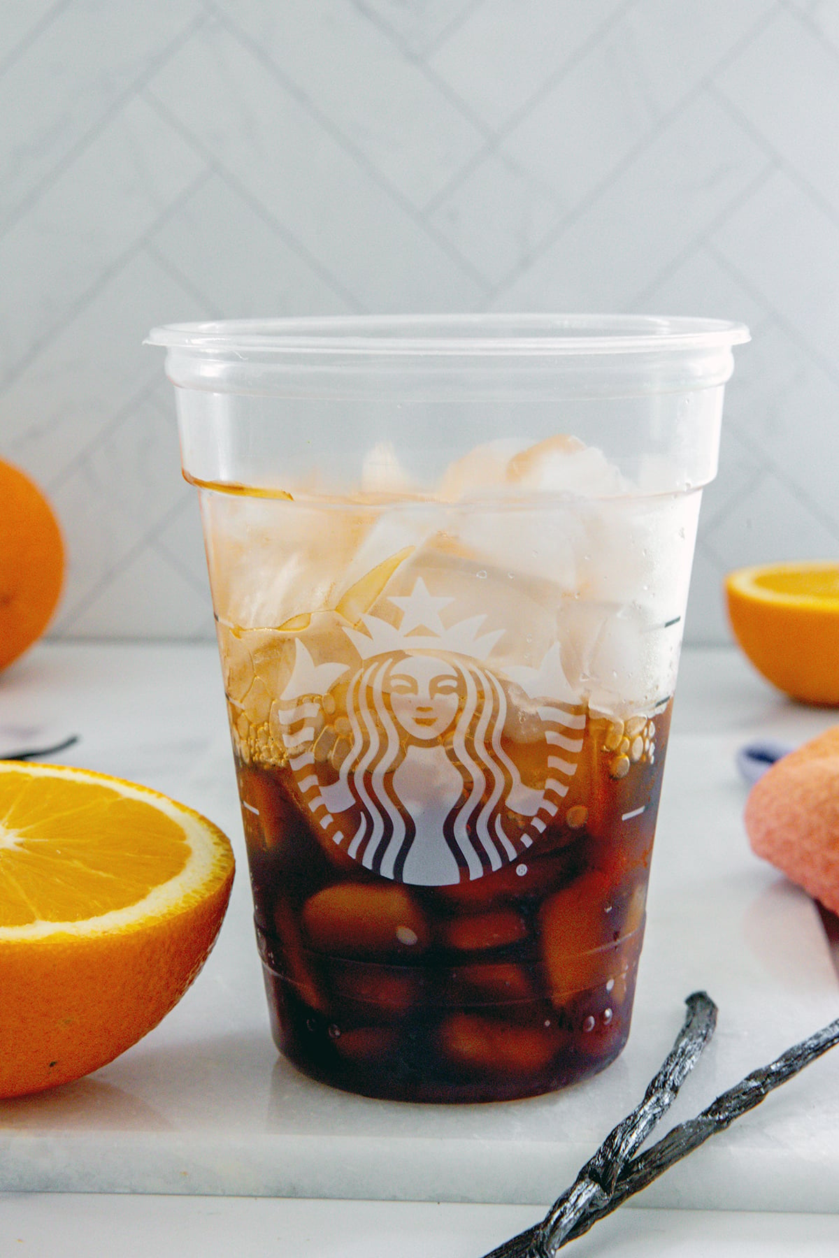 Starbucks cup with espresso, orange syrup, and ice.