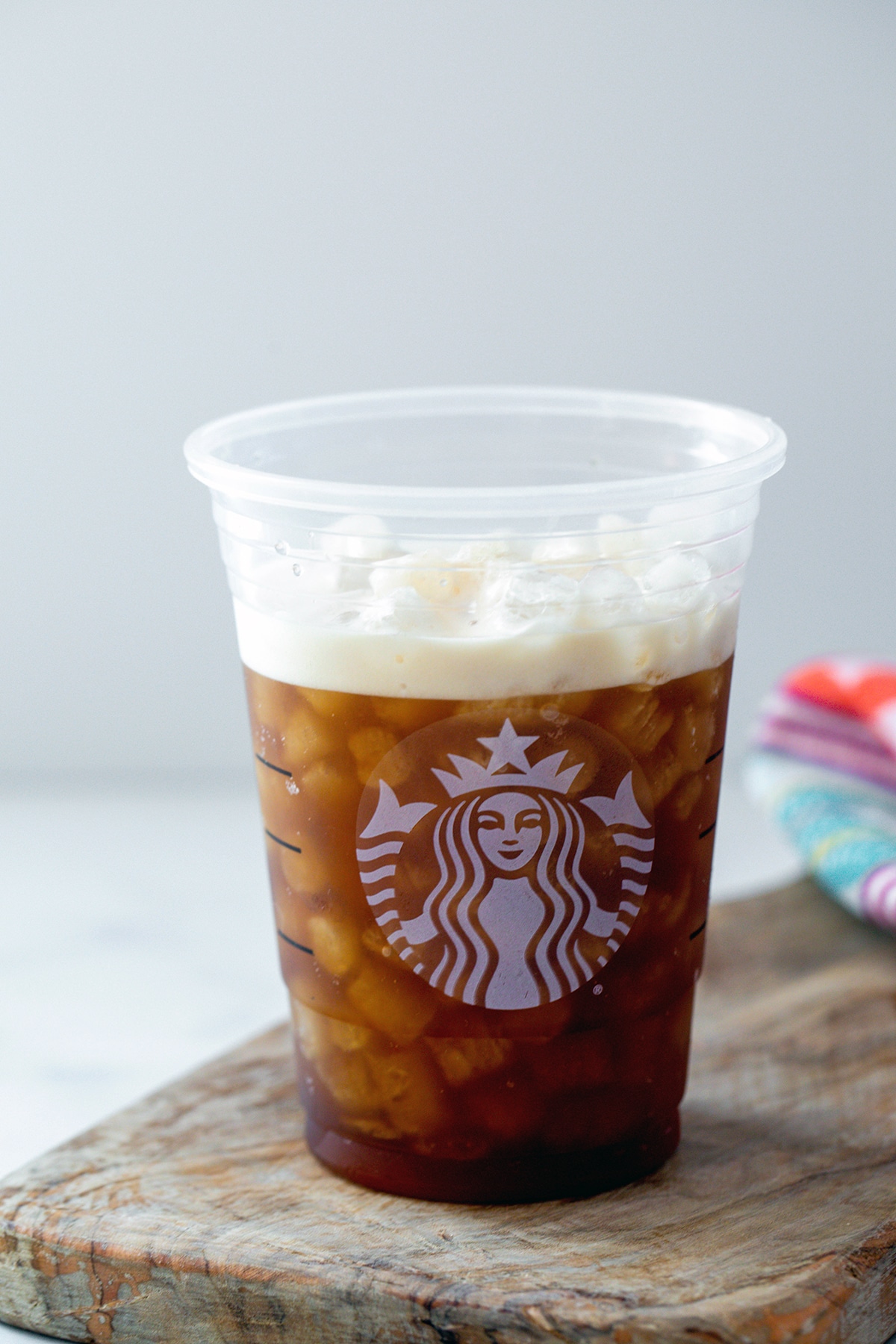 Shaken and frothy espresso and brown sugar syrup in Starbucks cup.