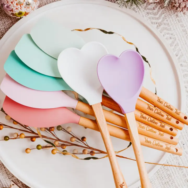 Heart-shaped silicone spatulas with the option to personalize on spatula handles.