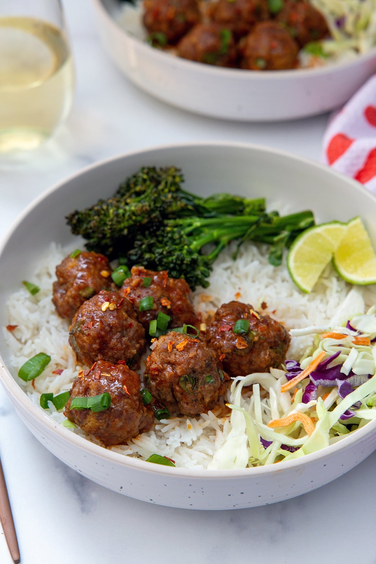 Spicy and sweet meatballs over coconut rice with slaw and broccolini.