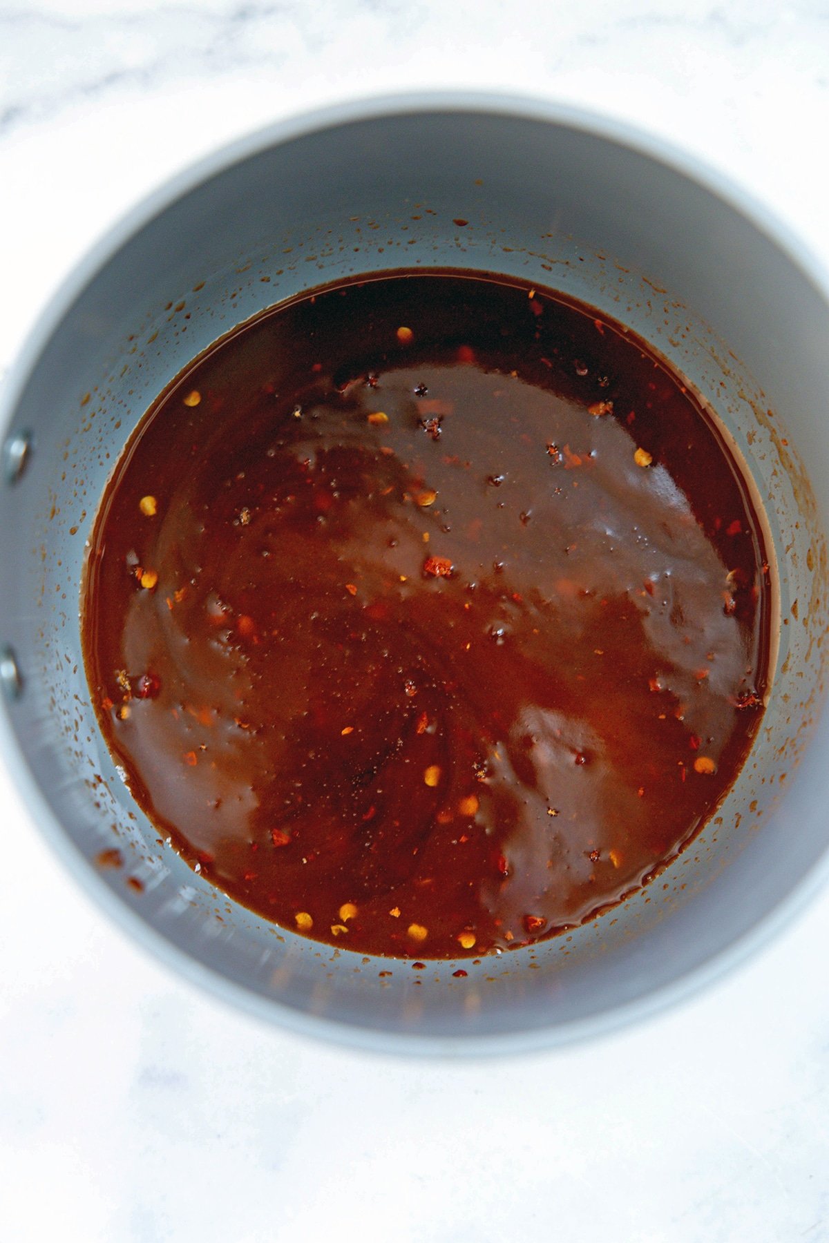 Sweet and spicy sauce ingredients in a saucepan.