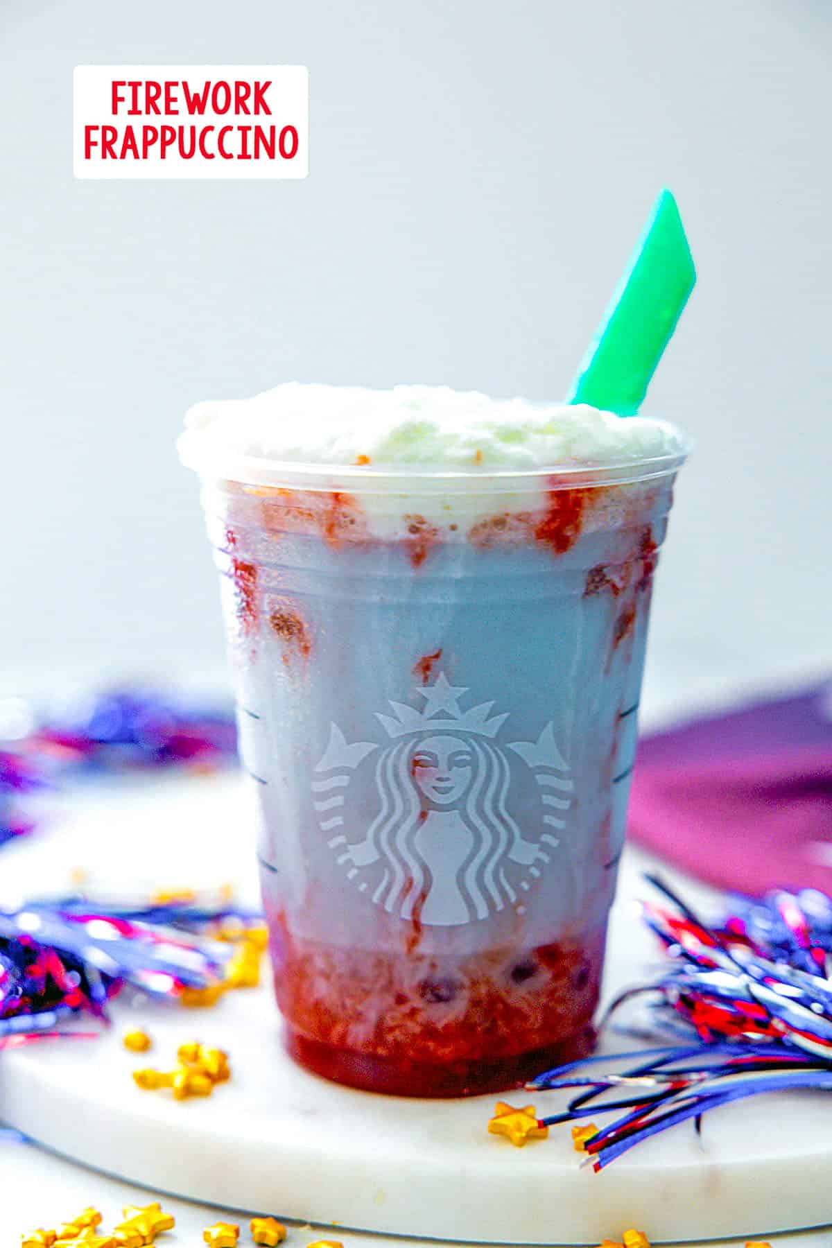 Head-on view of a Starbucks Firework Frappuccino with gold stars around and recipe title at top.