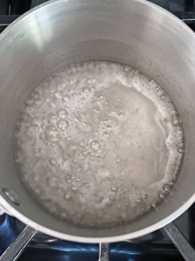Syrup boiling in saucepan.