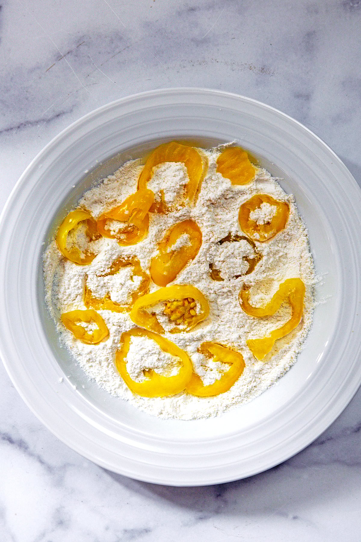Banana peppers in flour.