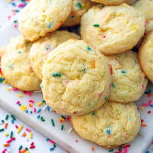 Closeup view of funfetti cake mix cookies with sprinkles all around.