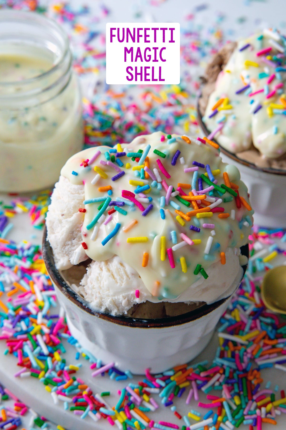 Scoop of ice cream topped with funfetti magic shell with sprinkles with second bowl and jar of magic shell in background and recipe title at top.