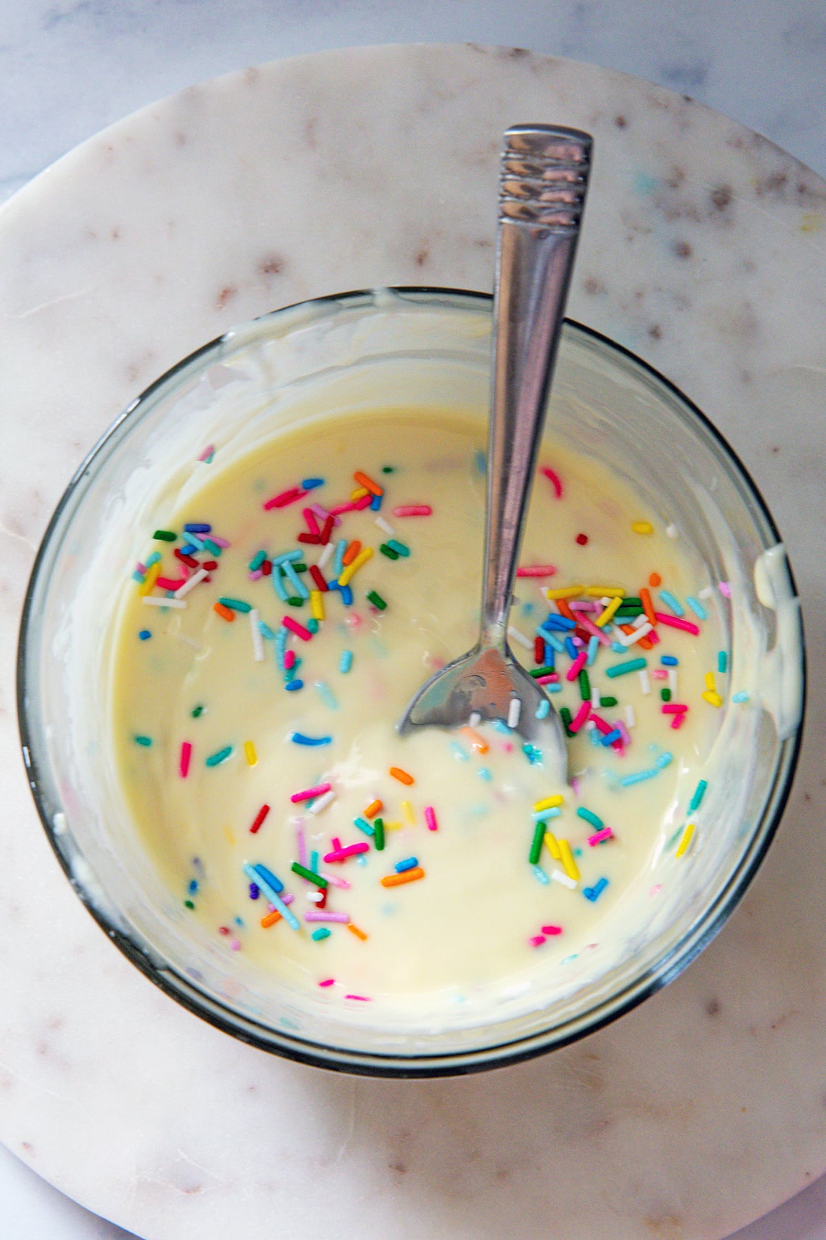 White chocolate magic shell with rainbow sprinkles mixed in.